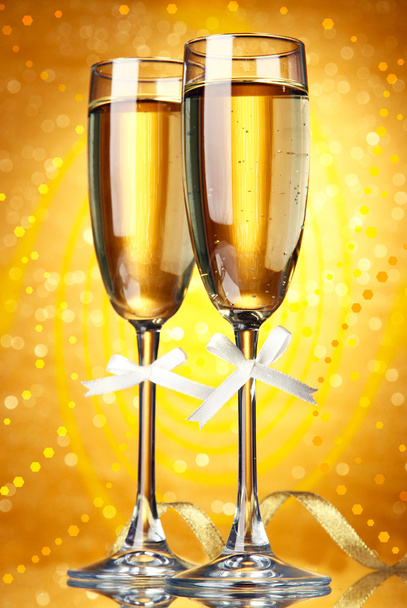 Glasses of champagne on bright background - 写真・画像