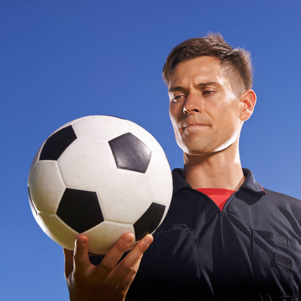 The match ball. a young footballer holding a ball in his hand - Foto, Imagen