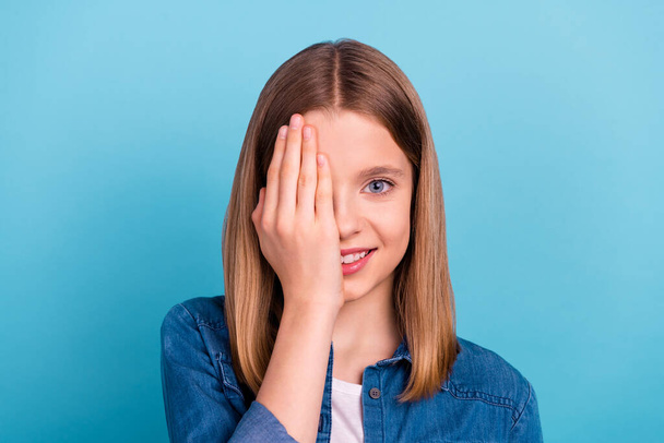 Photo of lovely teen blond girl close eye wear jeans shirt isolated on blue color background. - Fotoğraf, Görsel