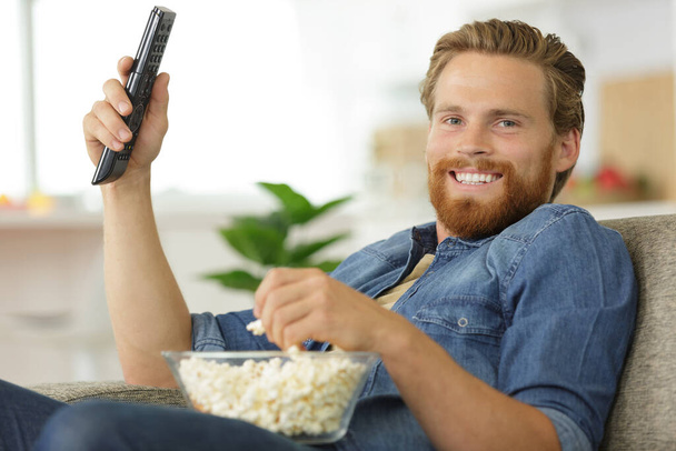 man watching tv home relax - Фото, изображение