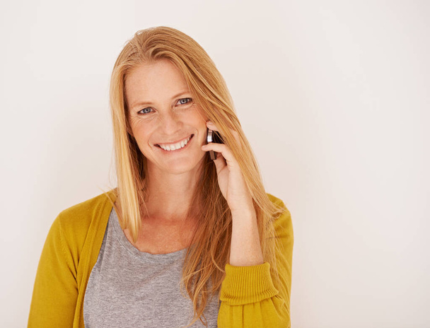 Their customer service is so friendly. Portrait of a happy woman talking on a mobile phone - Photo, Image