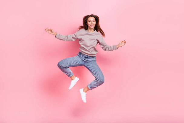 Full body photo of satisfied glad lady jumping have good mood isolated on pink color background. - Foto, Bild