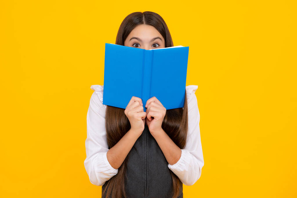 Schoolgirl with copy book posing on isolated background. Literature lesson, grammar school. Intellectual child reader - Foto, immagini