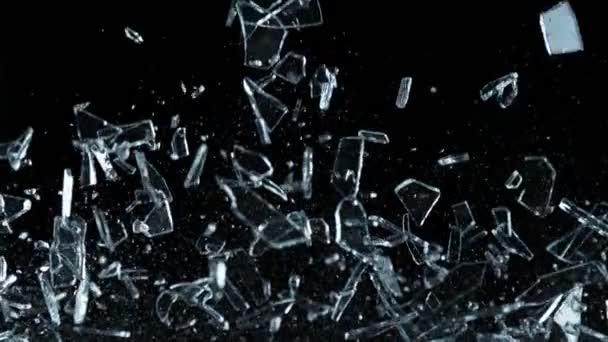 Super Slow Motion Shot of Flying and Shattering Glass Shards Isolated on Black a 1000fps. Girato con cinepresa ad alta velocità, 4k. - Filmati, video