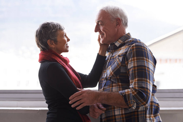 Youre as handsome to me as the day we met. a senior couple enjoying an affectionate moment - Foto, imagen