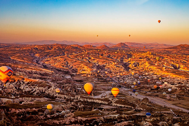 flight of hot air balloons in the circumference of Cappadocia at sunrise, top view, horizonta - Photo, Image