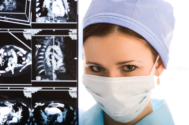 Young female doctor with tomogram - 写真・画像
