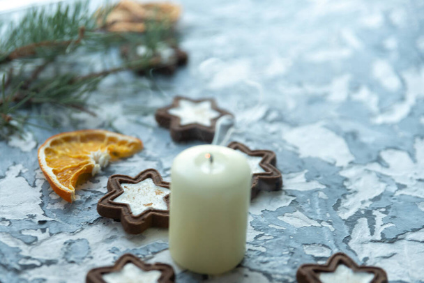 Christmas still life candles gray background and gingerbread. - Фото, изображение