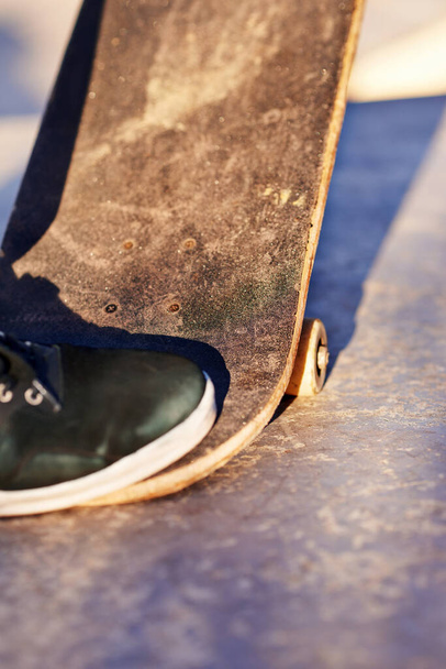 Stepping it up. Closeup shot of a skater stepping on his skateboard - Valokuva, kuva