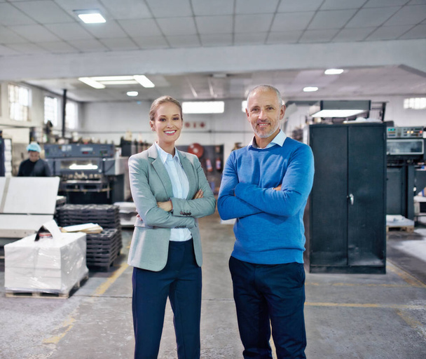 Weve got production sorted. Portrait of two colleagues standing together in a printing factory - Fotó, kép