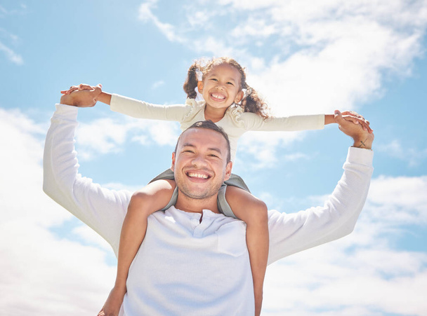 Family, girl child and father on holiday with clouds blue sky, sunshine and summer. Happy, care and love and dad playing with youth kid portrait on vacation break enjoying, having fun and piggyback. - Photo, Image