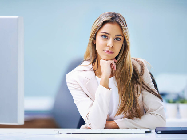 Ready to take on any project. Portrait of an attractive young businesswoman sitting at her office desk - 写真・画像