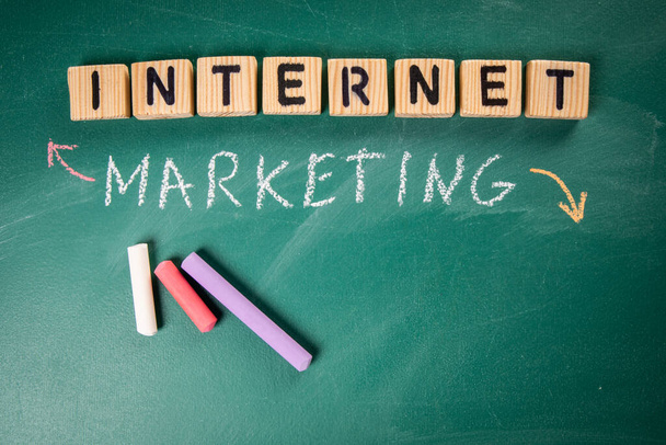 Internet Marketing concept. Wooden blocks. Green chalkboard background. - Photo, Image