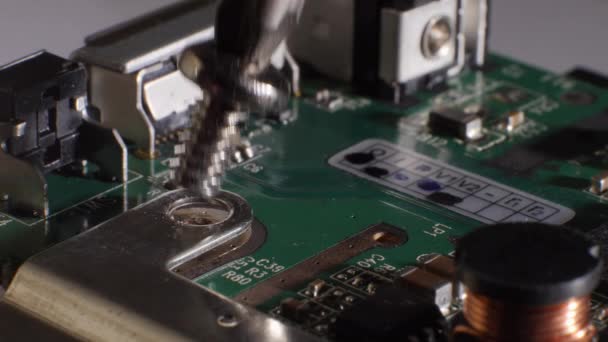 Closeup shot of a screw being inserted into a hard drive. Screwdriver. Fixing computer technology. Microchip. Storage. Different small components. Selective focus. - Footage, Video