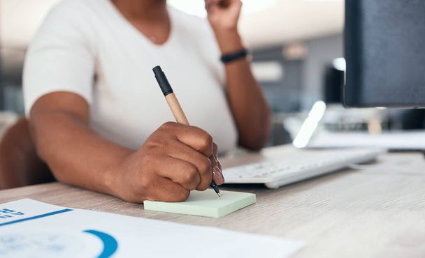Receptionist, secretary or consultant with phone, writing client info on sticky note. Crm, communication and support, customer service at telemarketing company. Black woman consulting on office phone. - Photo, image