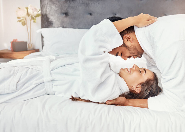Couple holiday, hotel bedroom and happy on luxury vacation for wedding celebration, smile for love on bed and happiness hug together in house. Man and woman relax with romance in house apartment. - Fotoğraf, Görsel