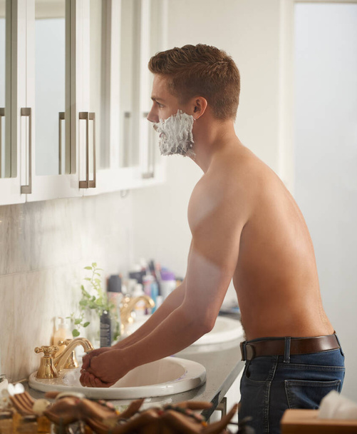 Time to get rid of this beard. Cropped portrait of a man shaving in his bathroom - Photo, Image