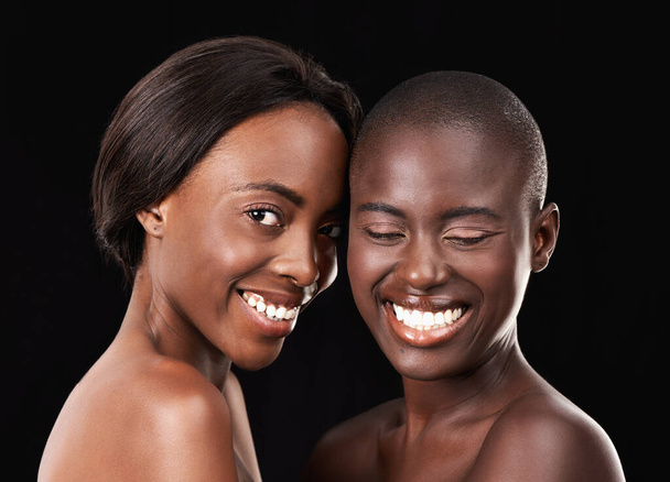 True beauty. Two beautiful african women standing together against a black background - Foto, Imagem