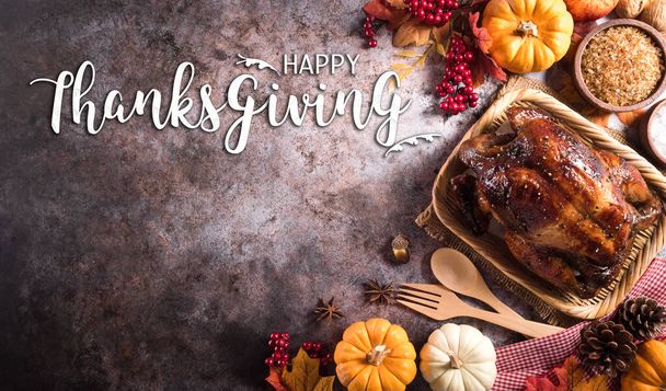 Thanksgiving dinner background concept with turkey roasted and all sides dishes, fall leaves, pumpkin and seasonal autumnal decor on dark stone background, top view, copy space. - Photo, Image