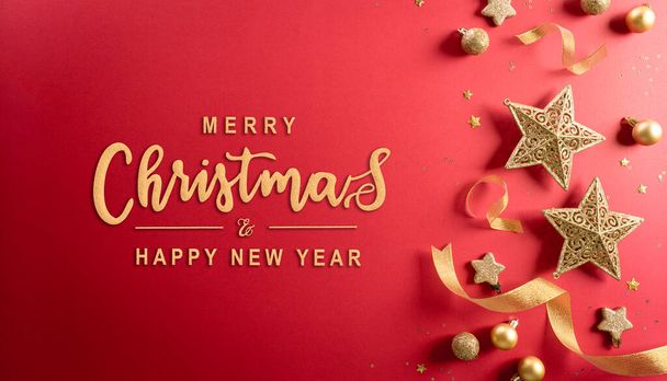 Christmas and new year background concept. Top view of Christmas decoration made from snowflake, christmas ball and  star on red background. - Photo, Image