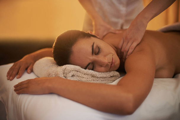 Getting a deep tissue massage. an attractive woman enjoying a relaxing massage - Photo, Image