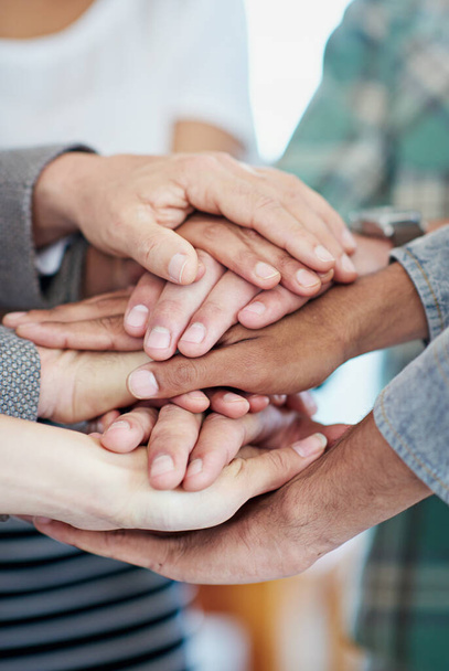 Business unity. a group of coworkers with their hands in a huddle - Foto, immagini