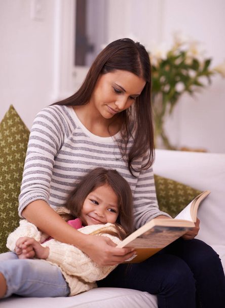 Dieses hat ein Happy End. eine junge Mutter liest ihrer Tochter zu Hause vor - Foto, Bild