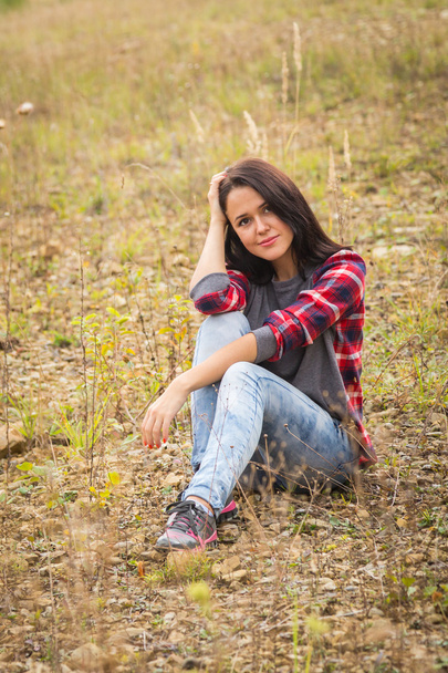 Brunette woman in casual clothes on nature - Photo, Image