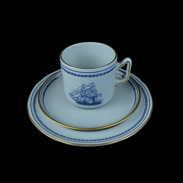 Antique British blue porcelain tea set with ship motifs.antique cup and saucer with a picture of a ship service close-up - Fotó, kép