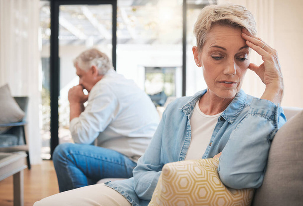 Mature couple, stress or divorce fight in house living room or home interior sofa. Angry, sad or depression woman face with anxiety in cheating affair argument with man in marriage therapy counseling. - Foto, Imagen