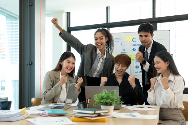 Portré siker és csapatmunka koncepció. Üzleti partnerek csoportja felemelt kézzel a könnyű modern munkaállomáson, megünnepelve az áttörést a vállalatukban. - Fotó, kép