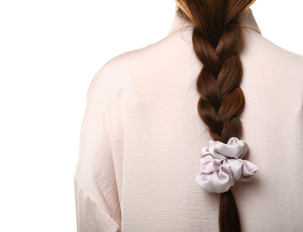 Woman with pigtail and silk scrunchy on white background - Fotografie, Obrázek