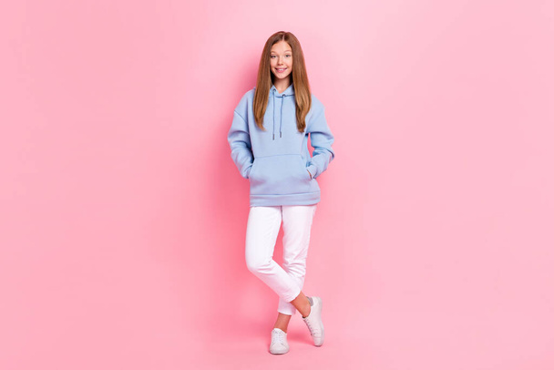 Full size photo of satisfied cute girl put arms pockets have good mood isolated on pink color background. - Foto, Imagen