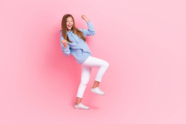 Full length photo of overjoyed delighted girl raise fists celebrate achievement isolated on pink color background. - Фото, изображение