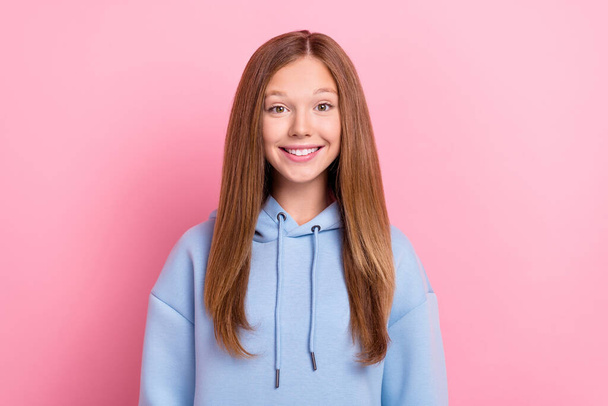 Photo of young adorable cute pretty small schoolgirl brown hair toothy smile positive mood wear blue hoodie isolated on bright pink color background. - Zdjęcie, obraz