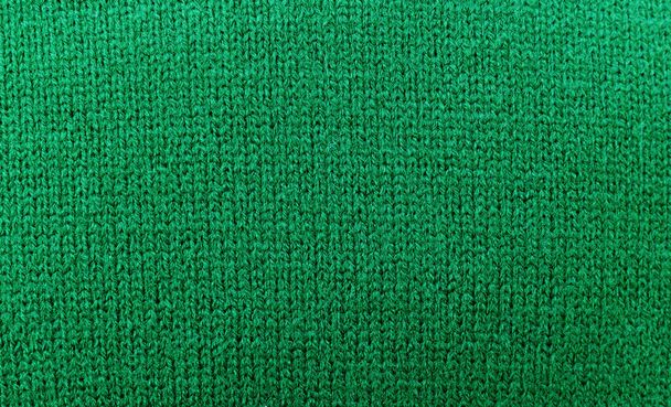 Zelený svetr pletená textura pozadí, zblízka, horní pohled, kopírovací prostor. - Fotografie, Obrázek