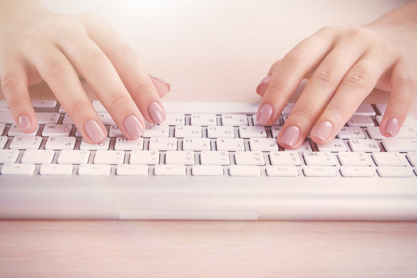 Female hands typing on keyboard on light background - Zdjęcie, obraz