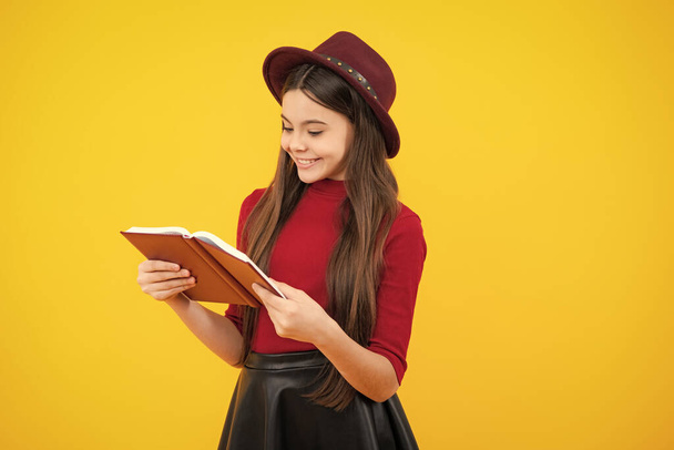 Happy teenager portrait. Teen girl pupil hold books, notebooks, isolated on yellow background, copy space. Back to school, teenage lifestyle, education and knowledge. Smiling girl - Фото, изображение