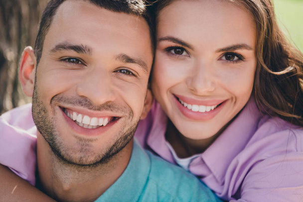 Photo of cute cheerful boyfriend girlfriend wear casual outfits smiling enjoying sunny weather outdoors garden. - Фото, изображение