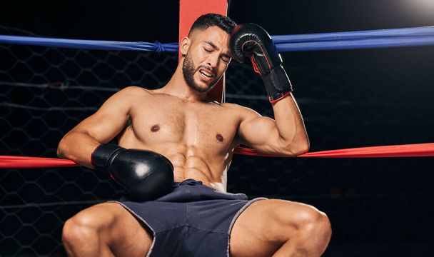 Sports, boxing ring and tired frustrated boxer with head pain, injury or fatigue from exhibition competition. Defeat or failure in fight challenge, workout or training burnout from fitness exercise. - Fotoğraf, Görsel