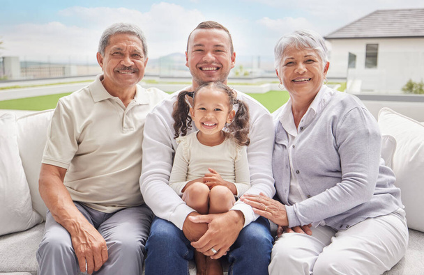 Big family portrait with child and grandparents on outdoor patio lounge in Mexico for summer holiday or vacation. Happy interracial father, kid and grandmother smile together with blue sky sunshine. - Photo, Image