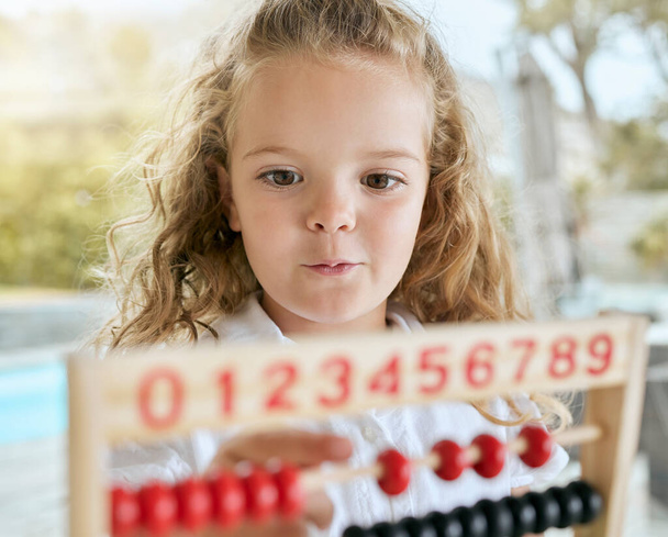 Abacus, math and kid learning numbers development with play beads, fun calculator and educational game. Happy, curious and excited kindergarten girl child counting toy, mathematics and home school. - Foto, afbeelding
