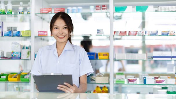 Pharmacist working in a pharmacy, Consultation and medical advice, All kinds of generic household drugs and pharmaceutical products on the shelf, Service and assistance to patients, Pharmacy. - Photo, Image