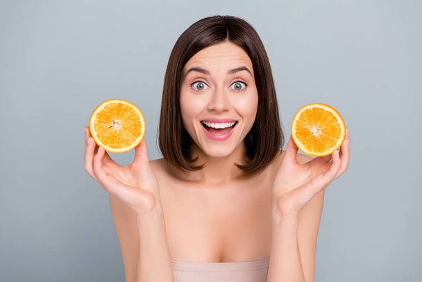 Photo of shocked lady hold two mandarin slices cream beauty product silky soft pure skin isolated on grey color background. - Foto, Bild