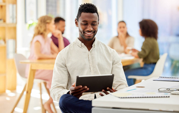 Afrykański biznesmen pracujący na tablecie cyfrowym siedząc przy biurku w biurze korporacyjnym. Szczęśliwy, profesjonalny i czarny człowiek prowadzi badania w Internecie lub na stronie internetowej z urządzeniem mobilnym - Zdjęcie, obraz