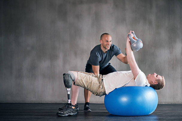 You can do it. a physiotherapist training with a patient - Photo, Image