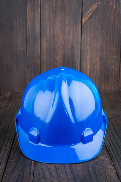 Construction hard hat on wooden background - Photo, Image