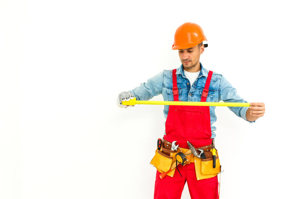 Construction worker pulling a rope. Full length studio shot isolated on white. - Photo, Image