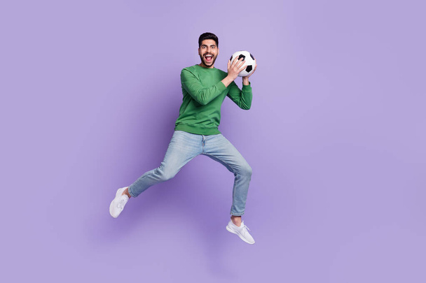 Full size photo of young hispanic man catch soccer ball football training dressed trendy green outfit isolated on violet color background. - Фото, зображення