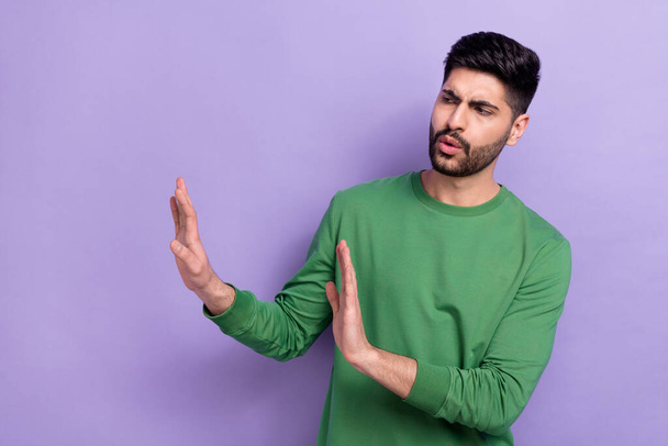 Photo of stylish handsome confused person dressed green pullover look empty space show no stop gesture isolated on violet color background. - Foto, imagen
